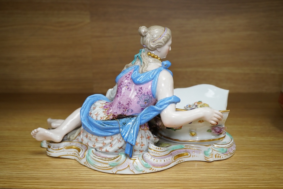 A Meissen female figural dish, 27cm wide. Condition - dish damaged (pieces in bag), crack near front knee